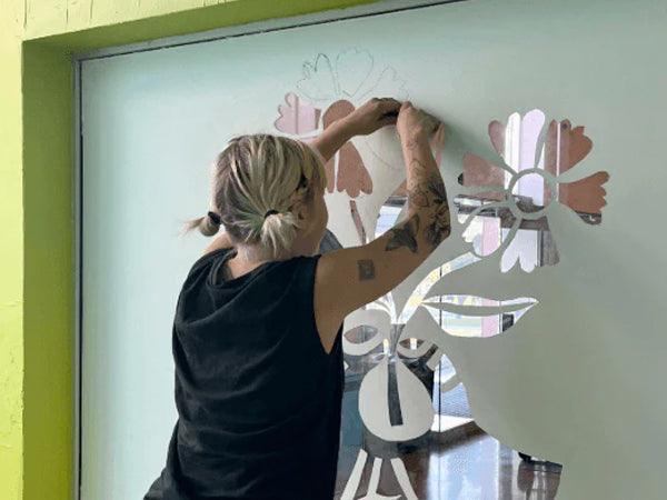 Abby installing mural at Agnes Etherington | Photo: Courtesy of the Artist