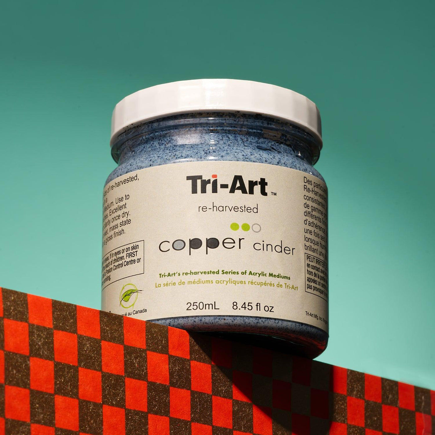 This is an image of a jar of Copper Cinder texture medium in the Tri-Art Acrylic Mediums line.