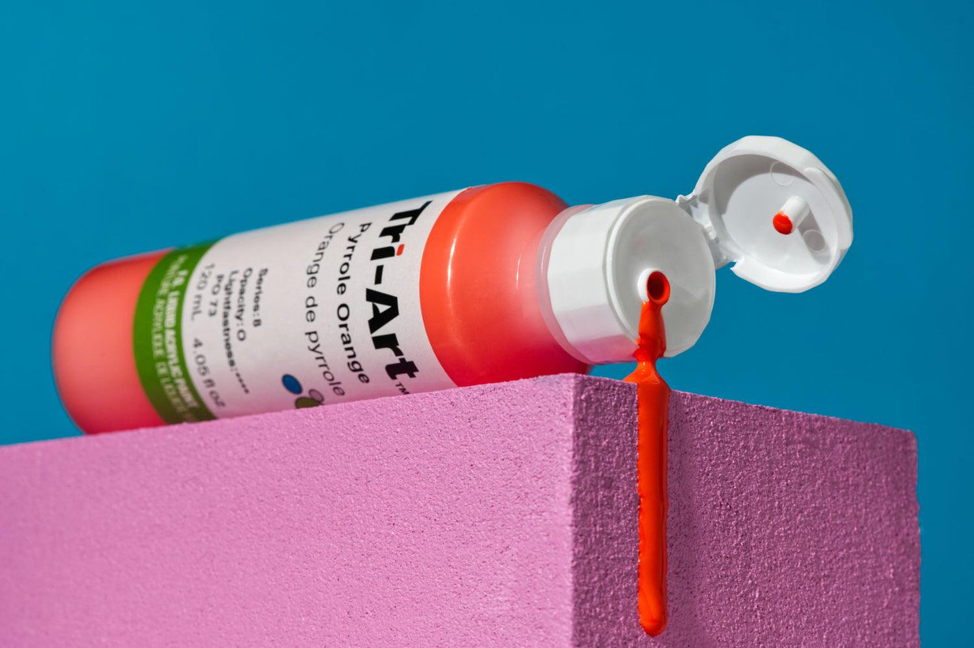This is an image of an open cylinder of Pyrrole Orange paint from the Tri-Art Liquids professional acrylic paint line.