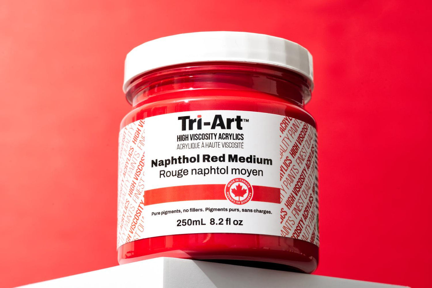 This is an image of a jar of Naphthol Red Medium from the Tri-Art High Viscosity acrylic paint line.