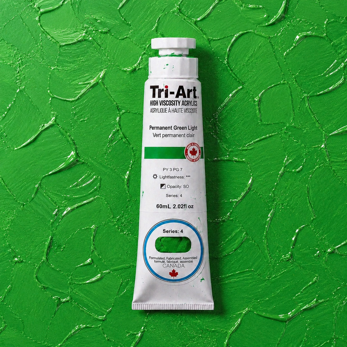 Tri-Art acrylic paint tube on a green textured background