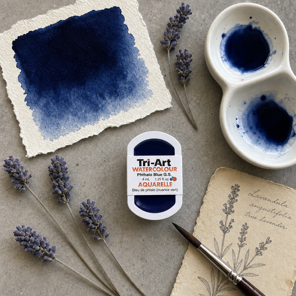 Tri-Art watercolor paint with a watercolor swatch, lavender flowers, and a brush on a textured surface.