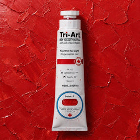 Tri-Art acrylic paint tube on a red textured background